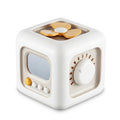 Curiously 6-in-1 Activity Cube, cream with mustard accents, showing three of its six mechanical faces